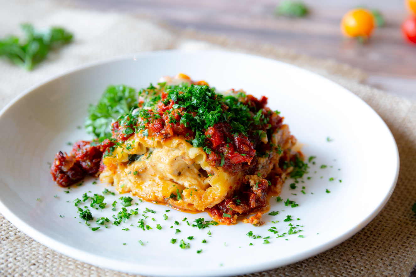 Chicken & Sun Dried Tomato Lasagna Rolls on Creamy Bacon & Pesto Béchamel