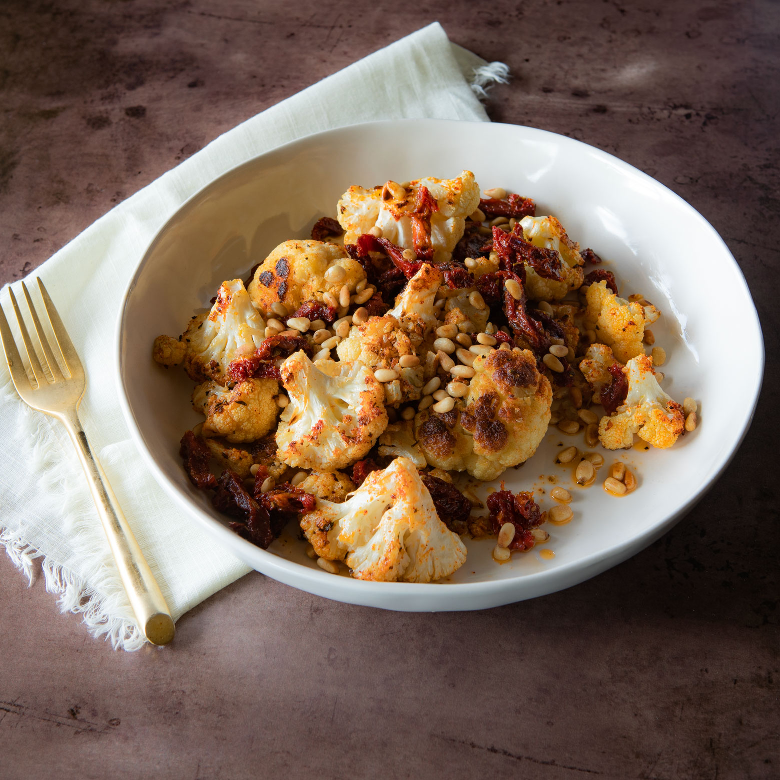 Roasted Cauliflower with Sun Dried Tomatoes and Pine Nuts