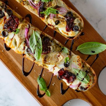 Basil Pesto Flatbread with Artichokes, Sun Dried Tomatoes, and Balsamic Glaze